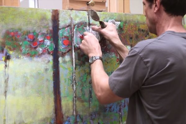 Painter Rick Stevens working on a painting with a painting knife