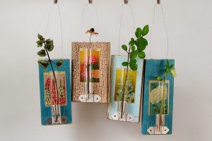 Seed packets on old wooden boards make floral art by Amy Duncan