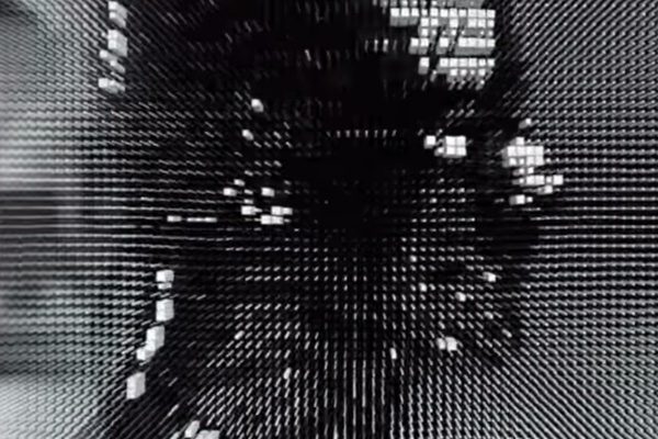 Pixel image of a human face in black and white