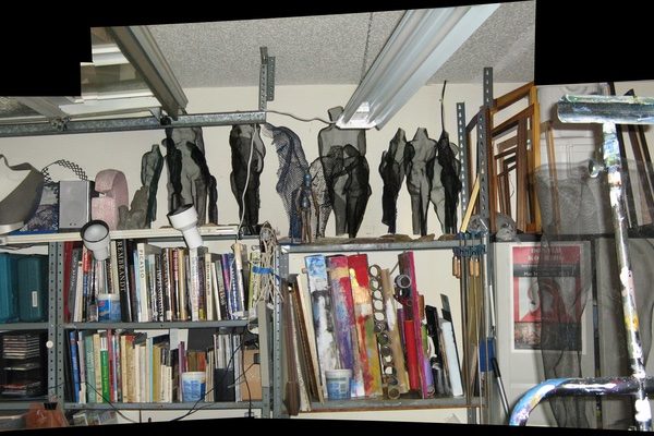 Donald Kolberg's studio, with mesh sculptures, materials, and art books