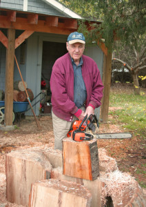 Artist Harry Wicks with chain saw blank.