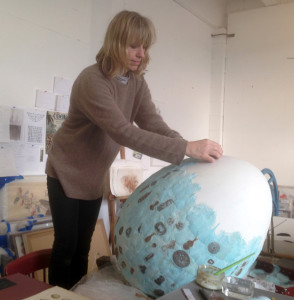 Rebecca Jewell working on a 3-D egg covered in Feather printing