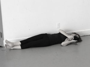 Tatiana Rivero Sanz on the floor, shooting a photograph, image to accompany video of composer photographer collaboration.
