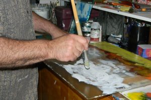 Donald Kolberg painting in his studio