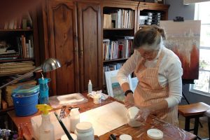 Painter Carolyn Land working in her studio