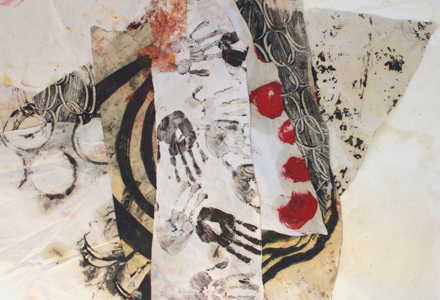 A painting of fabrics with inky handprints stamped on