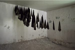 An installation of hanging canvas in an old army barracks