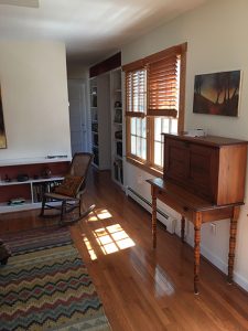 A desk and painting in a bedroom