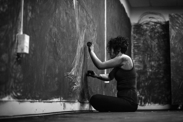 Artist Brianna Baurichter works on one of her charcoal drawings