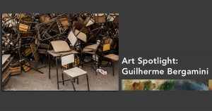 A photograph of a large number of school chairs haphazardly stacked on each other