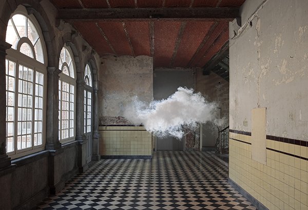 A photograph of an empty ornate hallway with a cloud in the middle