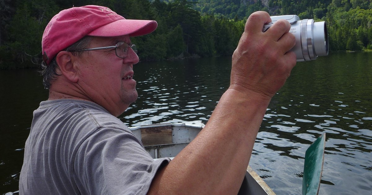 Artist Alan Bray takes a photograph from his canoe – The Woven Tale Press