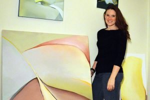 Artist Catherine Spencer poses with her paintings