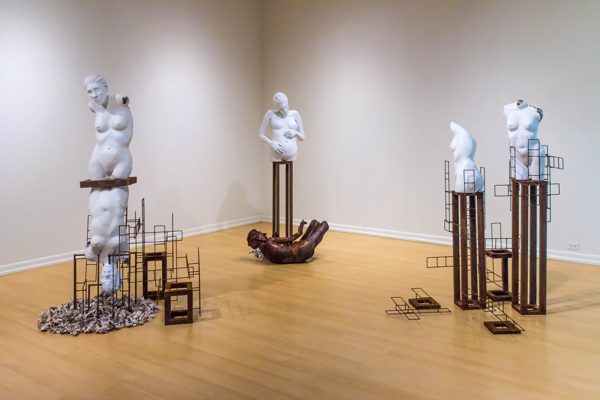 An installation of nude female busts sitting atop bronze bases