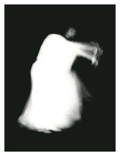 A black and white photograph of a ghostly white figure