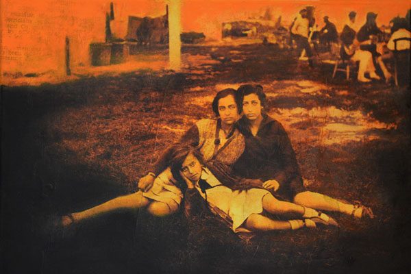 A red-toned photograph of a group of three girls posing together