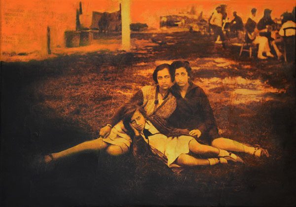 A red-toned photograph of a group of three girls posing together