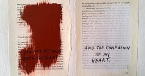 Ripped pages from a book with paint over the text, and new text written over
