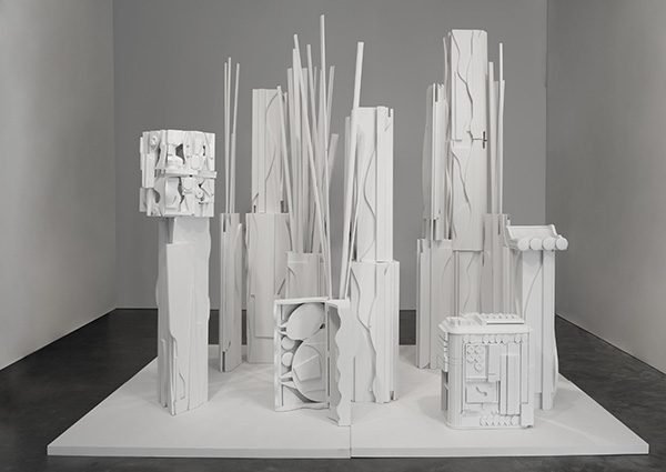 An all-white abstract sculpture installation