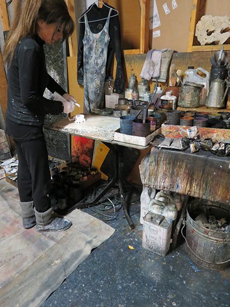 Josie Bell portions out paint for a work in progress in her artist studio