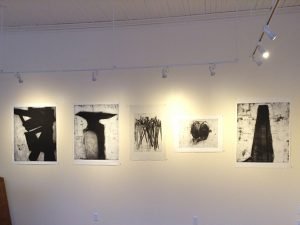 A selection of etchings hung on a gallery wall