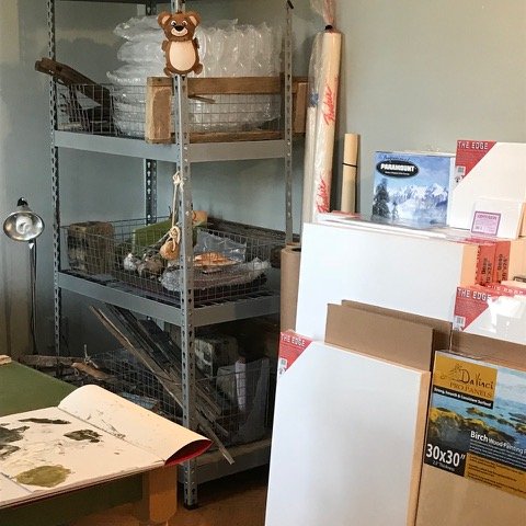 Shelves and empty canvases in the corner of an artist's studio