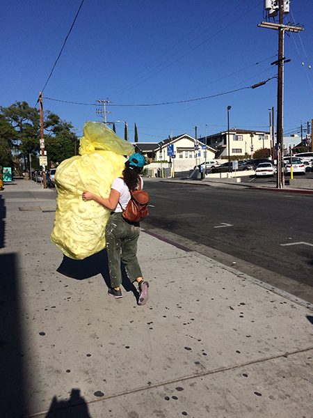 Installation artist Renae Barnard carries material to her shared studio