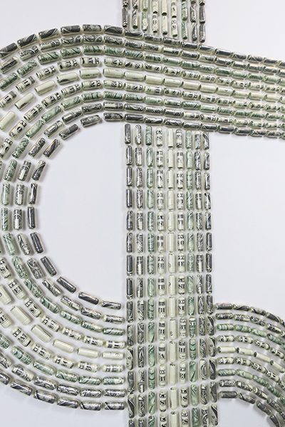 A dollar sign composed of rolled up dollar bills