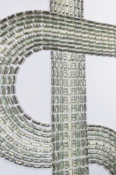 A dollar sign composed of rolled up dollar bills