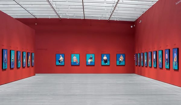 Installation view of a series of similarly themed portrait paintings