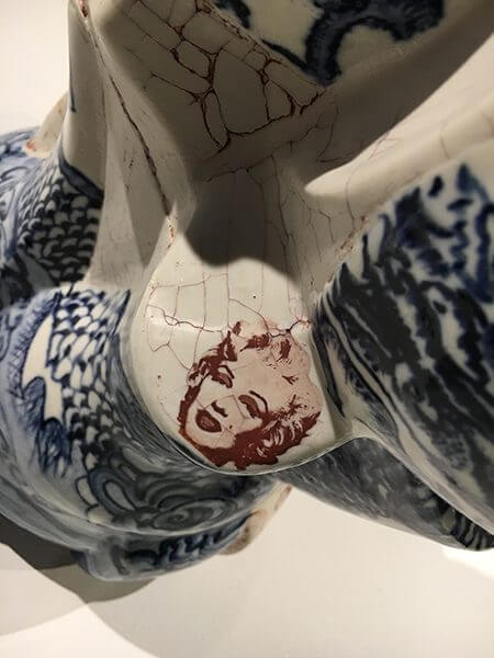 A close up of Marilyn Monroe's face painted onto a porcelain vase