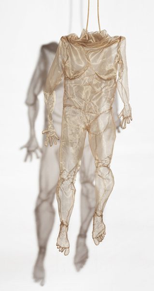 A stitched human form hanging from the ceiling