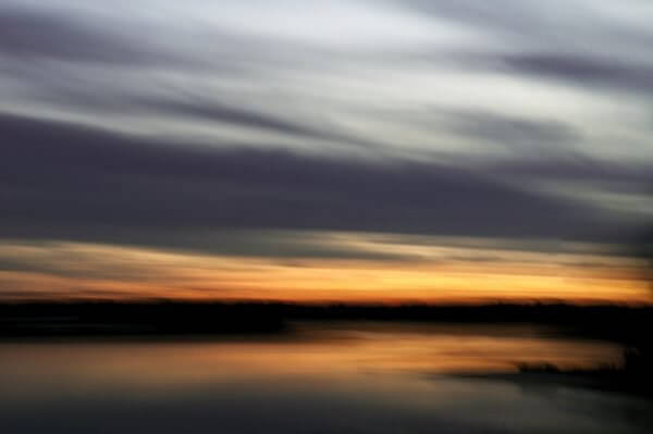 A photograph of a harbor at sunset