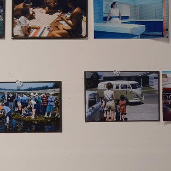 Photographs tacked onto the wall of a photographer's studio