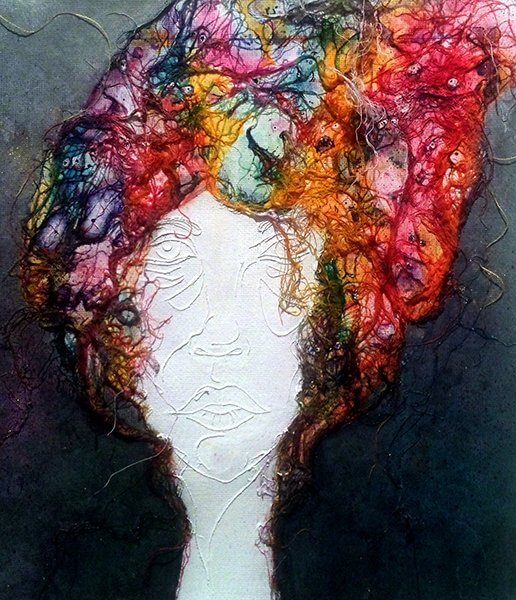 An abstract portion of a white painted face with colorful fibrous materials for hair