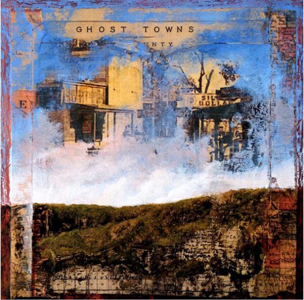An oil painting of a tree-covered hill and the sky painted on a postcard of a ghost town