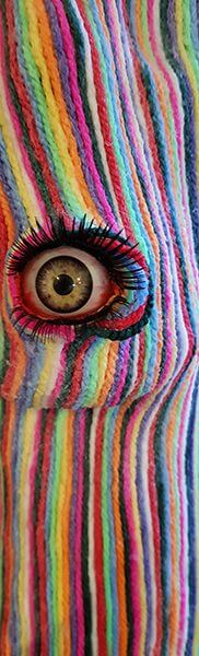 An abstract work of rainbow pieces of yarn in the shape of a face