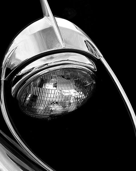 David Quinn, black and white photograph of a car headlight.