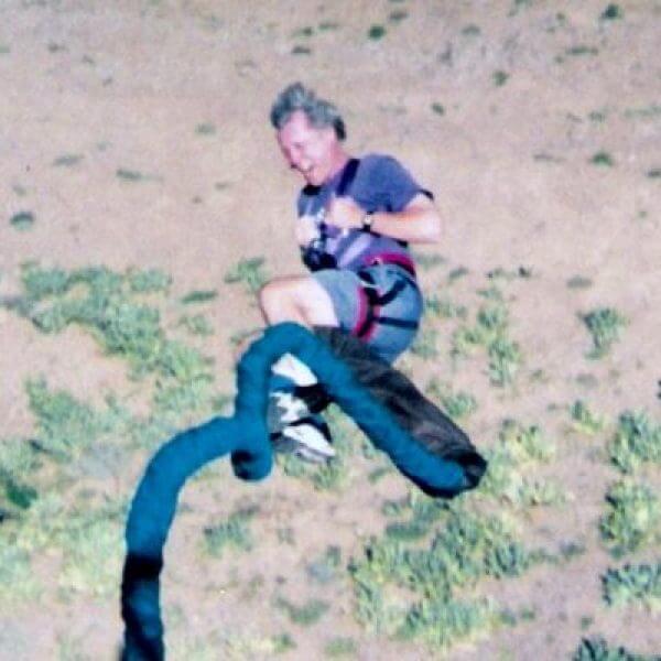 A man mid-bungee jump on his way down