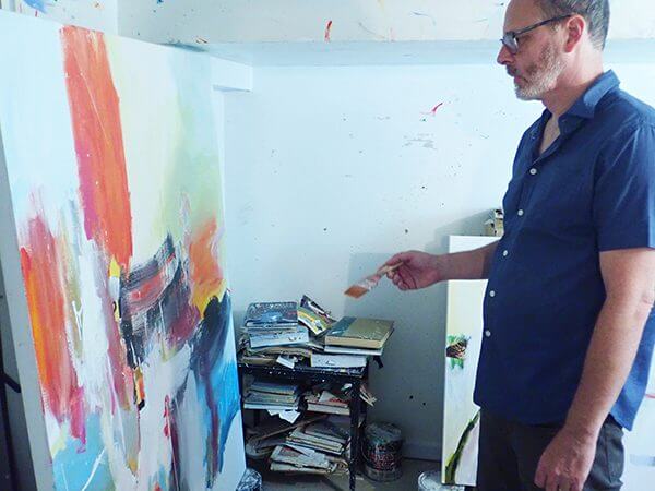 David Criner painting in his studio