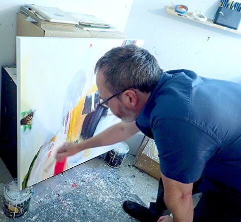 David Criner painting in his studio