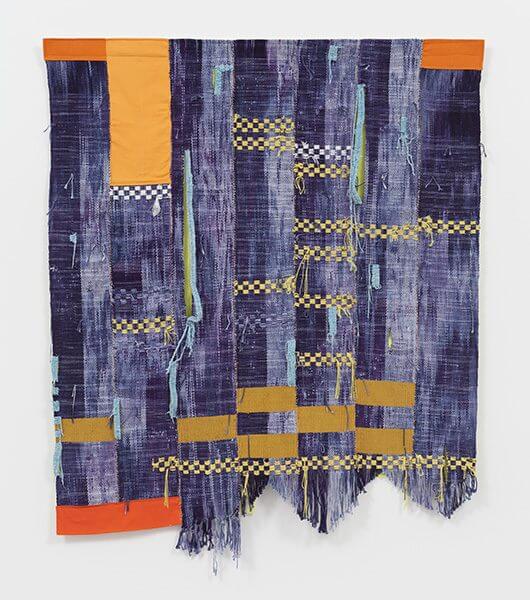 Fiber art with blue and orange strips of fabric sewn together