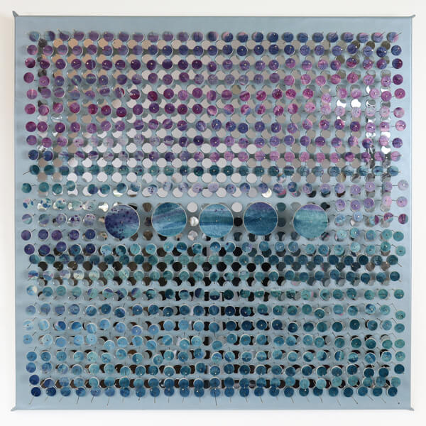 Laurie Borggreve's piece, with small circles of colored metal in front of small mirrors. 