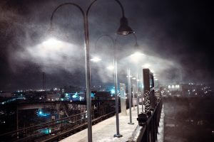 A photograph of a dock on a foggy night