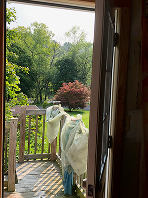 The view from an artist's house, overlooking a hill and trees