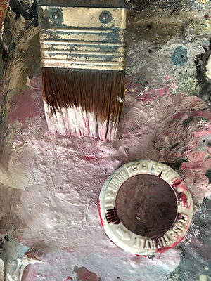A paintbrush and light pink paint