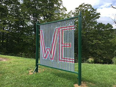 A sculpture with the word "We" painted on it