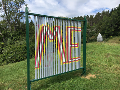 A sculpture with the word "Me" painted on it