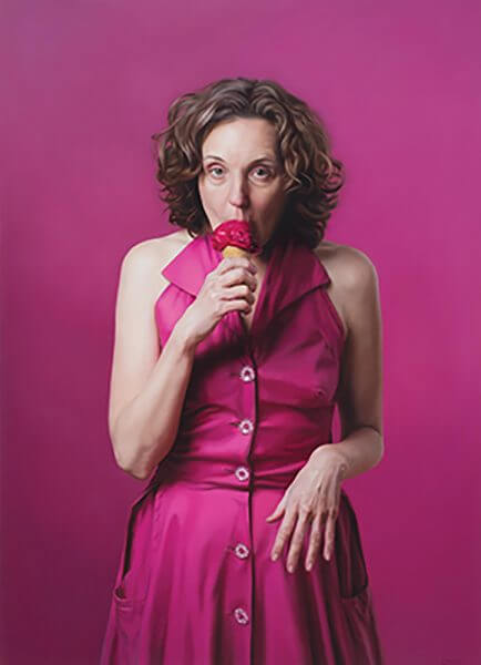 A portrait of a woman eating a raspberry ice cream cone