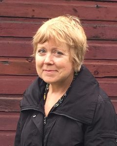 Portrait of poet Rachel Michaud in front of a red wall